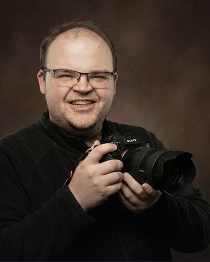 Daniel Orosz, the founder of Wedvero, holding his camera